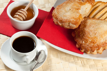 Breakfast including coffee, bread, honey.