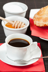 Breakfast including coffee, bread, honey.