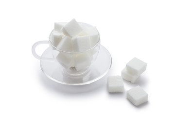 cubes sugar in glass cup isolated on white background