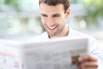 Businessman reading newspaper