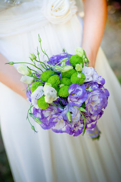 Woman holds wedding bouquet