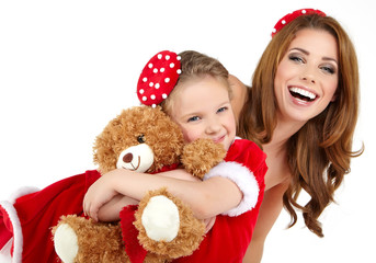 Fototapeta na wymiar Woman and little girl wearing santa claus costume