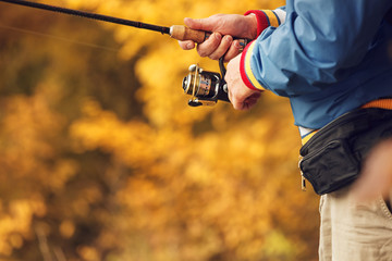 Fisherman`s hands with spinning.