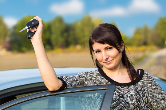 young girl with car key in hand