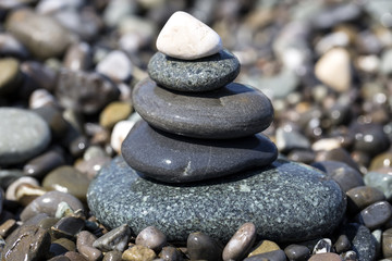 balancing stones wet on the beach