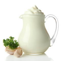 Sour cream in pitcher isolated on white