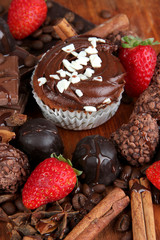 Tasty cupcake with different sweets close up