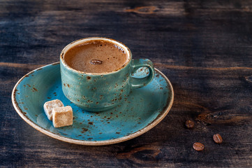 Сup of espresso coffee with sugar on vintage wooden background