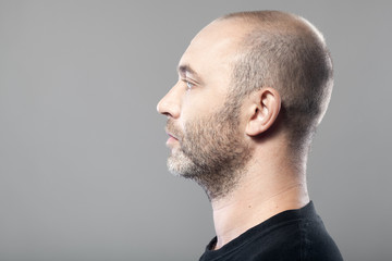 profile portrait of man isolated on gray background with copyspa