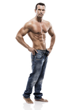 Muscle Man Posing In Studio, Isolated Over A White Background