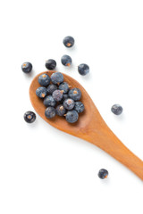 Wooden spoon with seeds of juniper