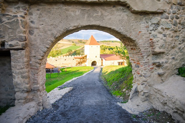 View through an old gate of a medieval fortress in Romania