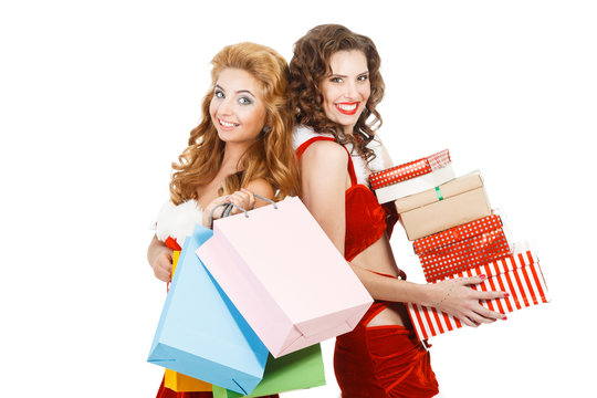 Two beautiful christmas girls holding gifts and packages