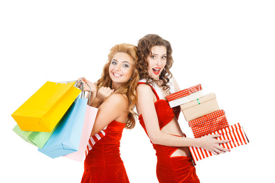 Two christmas girls isolated holding gifts and packages
