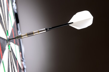 Dart in bulls eye of dartboard