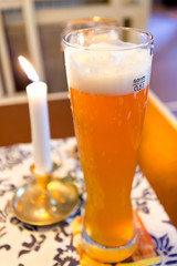 glass of german beer and lit candle