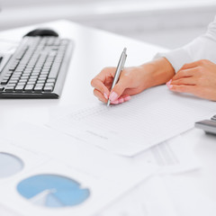 businesswoman working with calculator in office