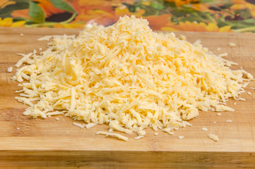 Grated cheese on a cutting board