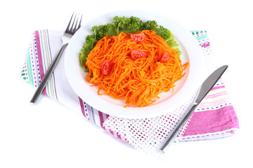 Carrot salad on plate on napkin isolated on white