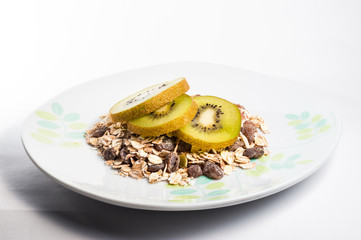 Muesli cereals bowl and spoon with almond, pine nuts, walnut, ra