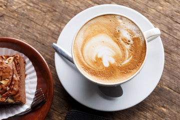 hot coffee with cake on grunge wood background