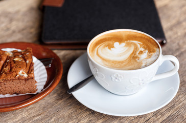 hot coffee with cake on grunge wood background