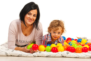 Fototapeta na wymiar Happy mom and son with colorful balls
