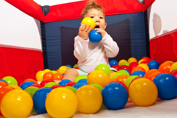 Fototapeta na wymiar Baby boy playing with balls