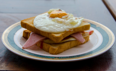 fried egg and ham sandwich on toast.