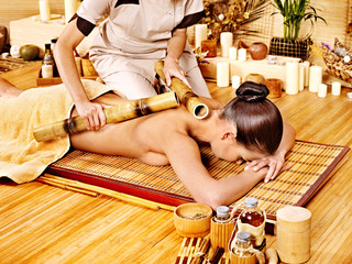 Woman getting bamboo massage.