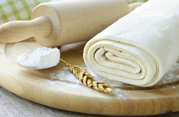 homemade dough  and flour on a wooden board