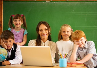 Group of happy classmates with their teacher