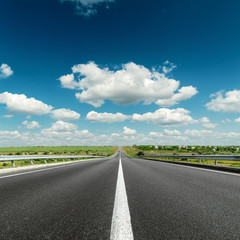 deep blue cloudy sky over asphalt road