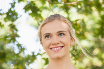 Cheerful young woman standing in a park