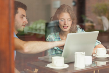 Two students looking at laptop