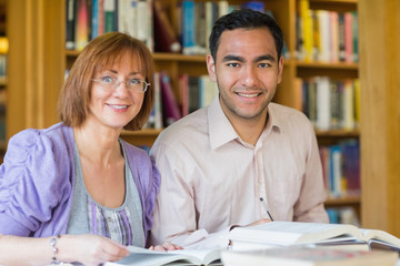 Adult students studying together in the library © WavebreakmediaMicro