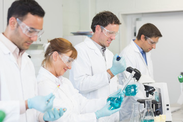 Naklejka na ściany i meble Group of scientists working at the laboratory