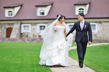 Fototapeta na wymiar Bride and groom walking together