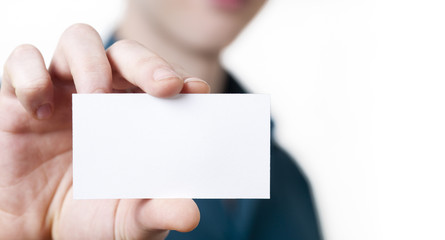 Casual young businessman holding business card.