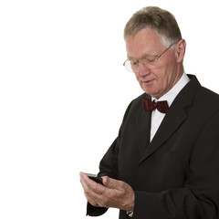 Senior Businessman texting on mobile phone