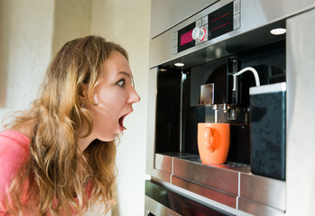 Fototapeta na wymiar shock woman making coffee cup machine kitchen interior