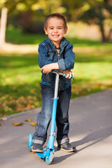 Laughing boy with scooter