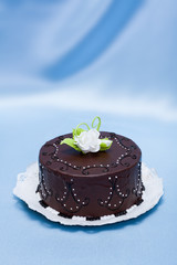 Chocolate cake with white candy rose decoration