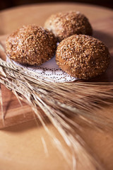 Fresh bread and wheat ears on the wooden table