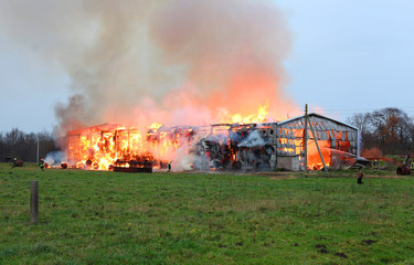 Fototapeta na wymiar Burning farm building with hay