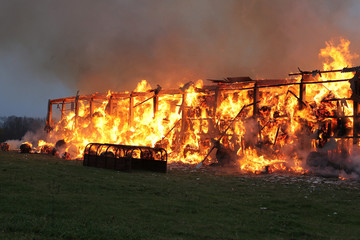 Burning farm building with hay