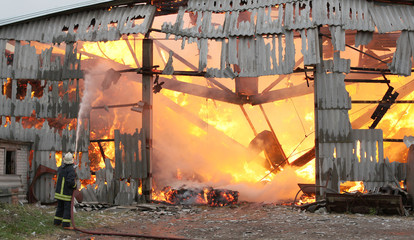 Burning farm building with hay