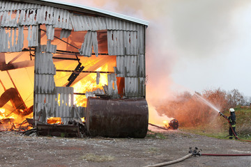Burning farm building with hay