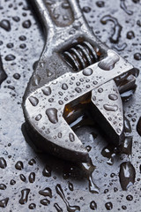 Adjustable wrench in water drops