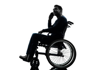 Fototapeta na wymiar handicapped man on the telephone in wheelchair silhouette